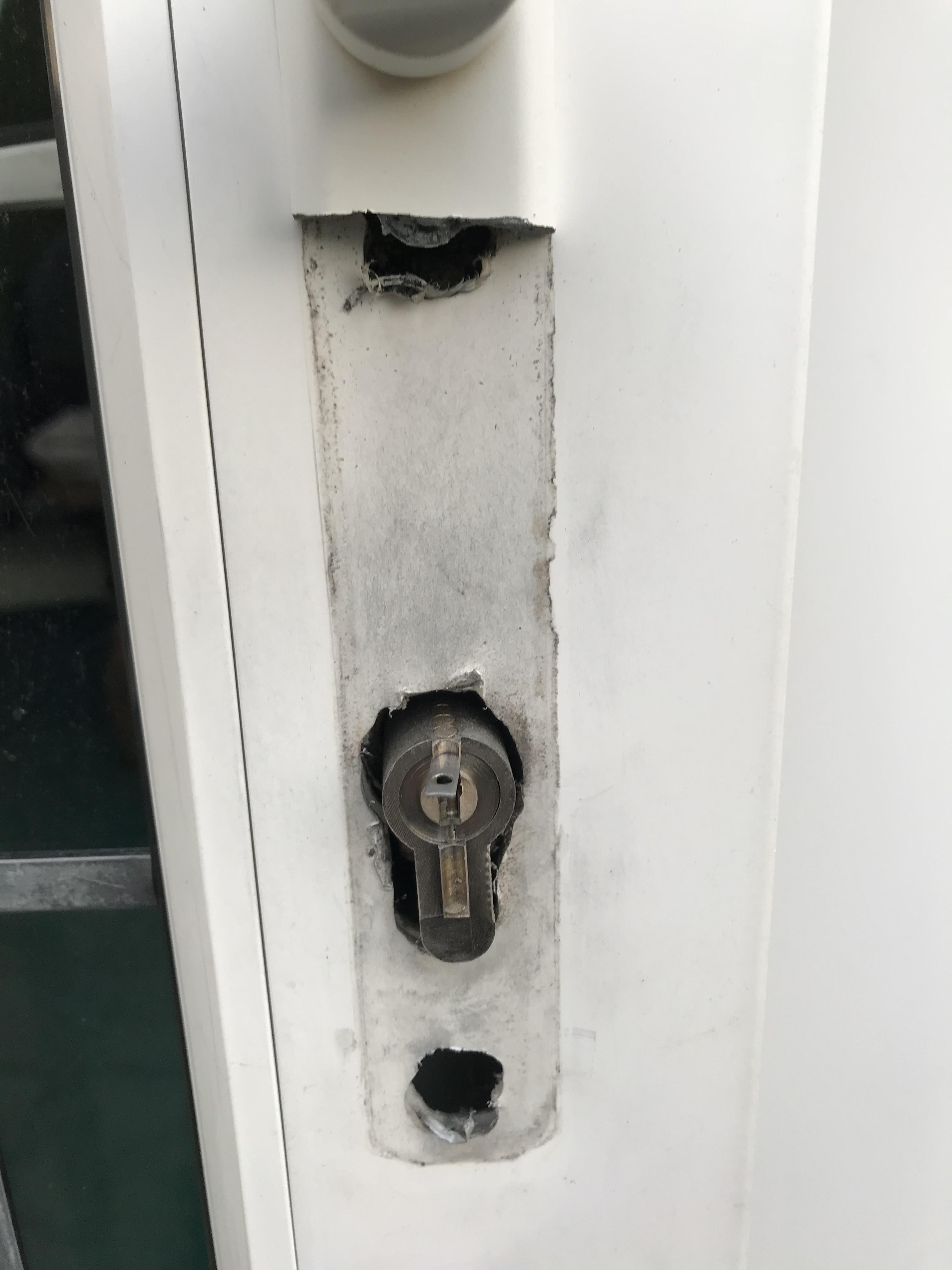 white upvc door with snapped lock and handle