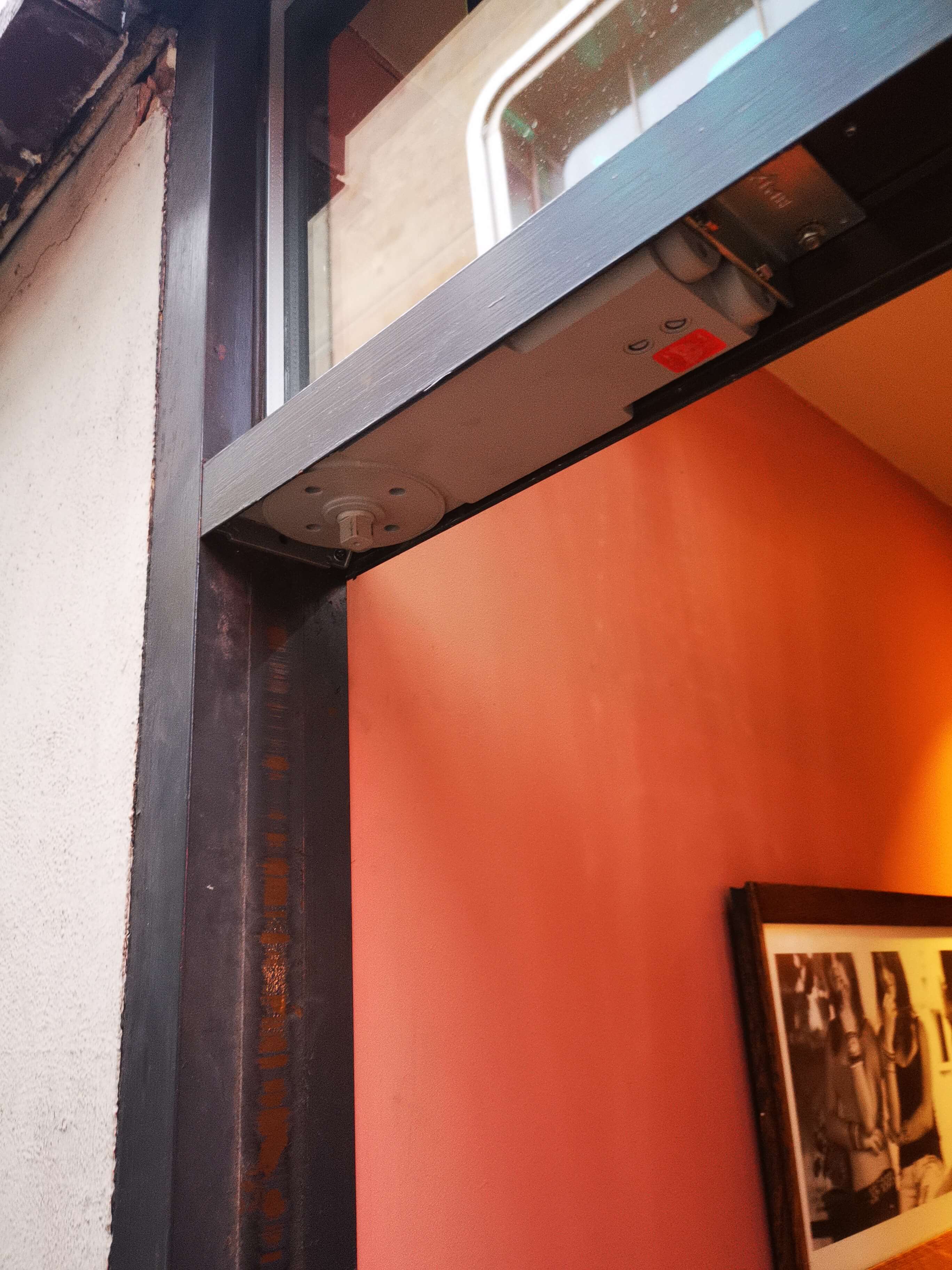 Axim concealed door closer fitted to café Nero in Leeds city centre