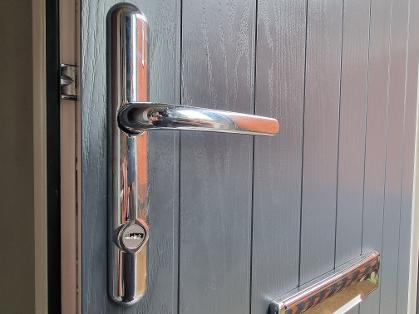 High security 2 star handle with cylinder guard fitted to anthracite grey door